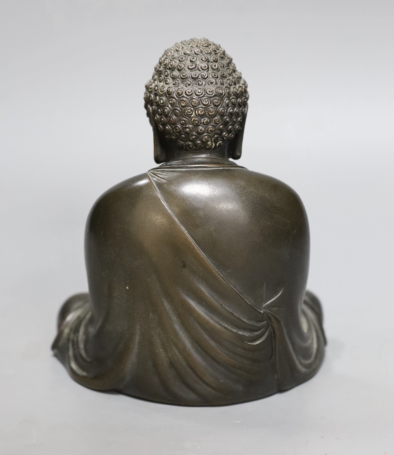An early 20th century Japanese bronze figure of a seated Buddha, signed, 17cm